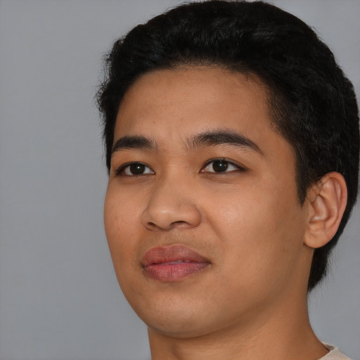 Joyful asian young-adult male with short  black hair and brown eyes