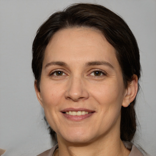 Joyful white adult female with medium  brown hair and brown eyes