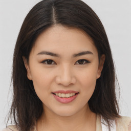 Joyful asian young-adult female with long  brown hair and brown eyes