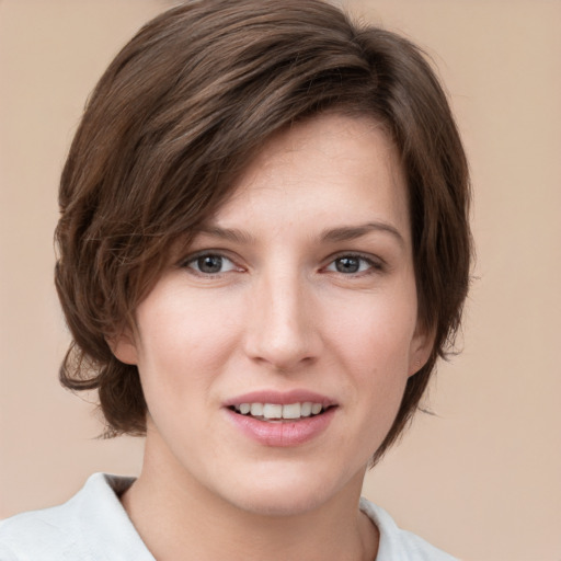 Joyful white young-adult female with medium  brown hair and grey eyes