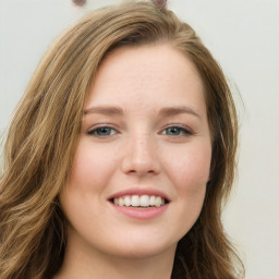 Joyful white young-adult female with long  brown hair and green eyes