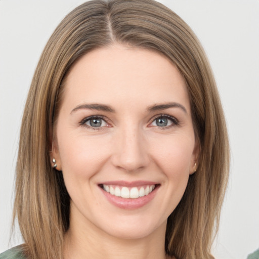 Joyful white young-adult female with long  brown hair and green eyes