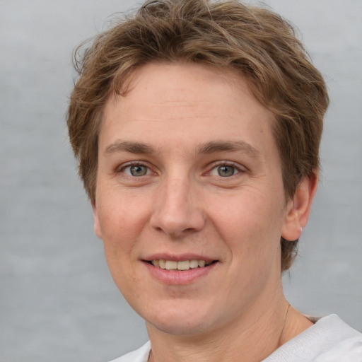 Joyful white adult female with short  brown hair and grey eyes