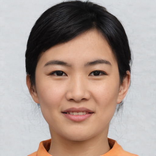 Joyful asian young-adult female with medium  black hair and brown eyes