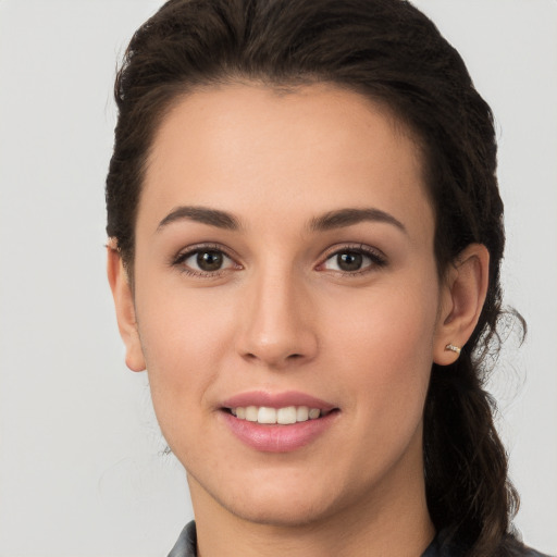 Joyful white young-adult female with long  brown hair and brown eyes