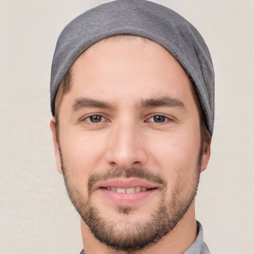 Joyful white young-adult male with short  black hair and brown eyes