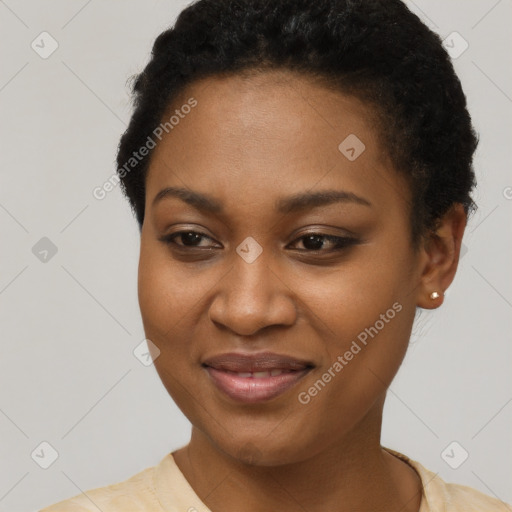 Joyful black young-adult female with short  brown hair and brown eyes