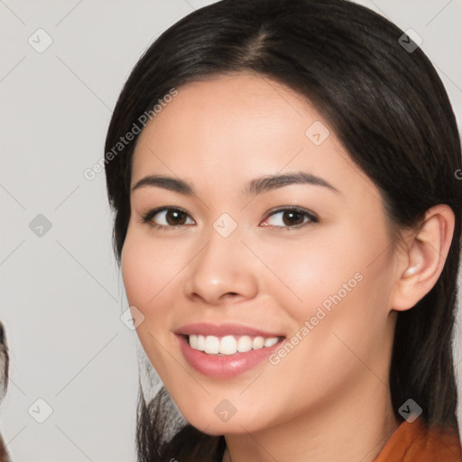 Joyful white young-adult female with medium  black hair and brown eyes