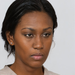 Neutral black young-adult female with medium  brown hair and brown eyes