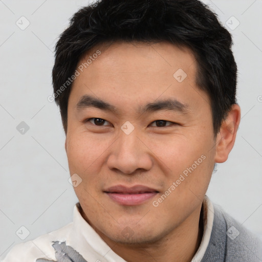 Joyful asian young-adult male with short  brown hair and brown eyes