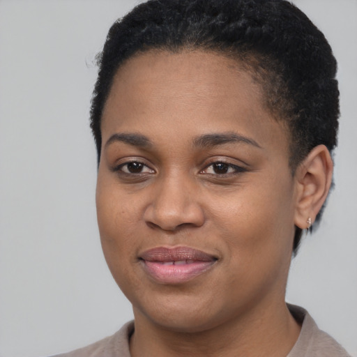 Joyful black young-adult female with short  brown hair and brown eyes
