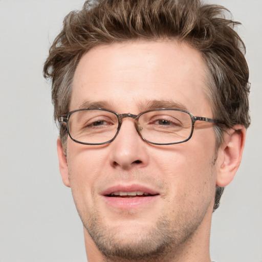 Joyful white adult male with short  brown hair and grey eyes