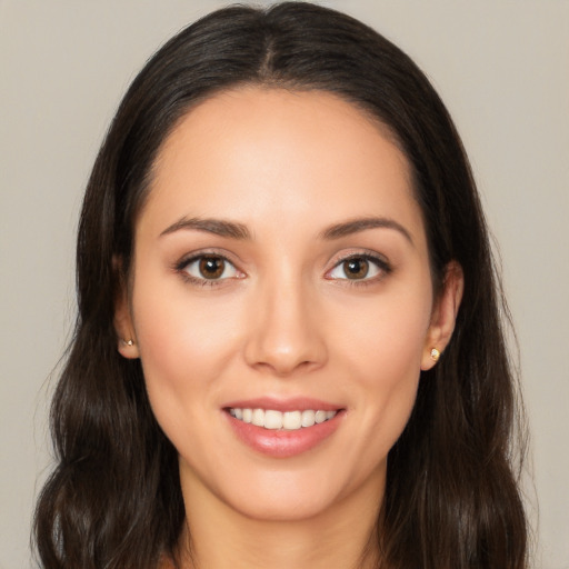 Joyful white young-adult female with long  brown hair and brown eyes