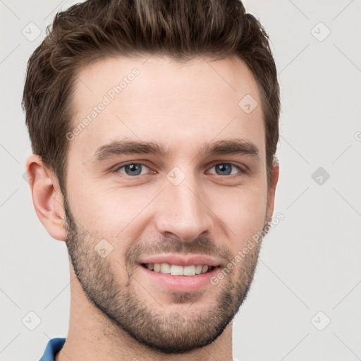 Joyful white young-adult male with short  brown hair and grey eyes