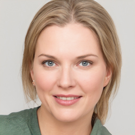 Joyful white young-adult female with medium  brown hair and blue eyes