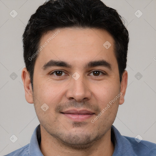 Joyful white young-adult male with short  black hair and brown eyes