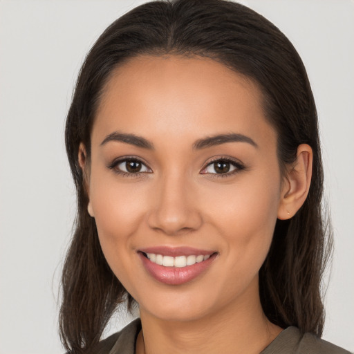 Joyful white young-adult female with long  brown hair and brown eyes