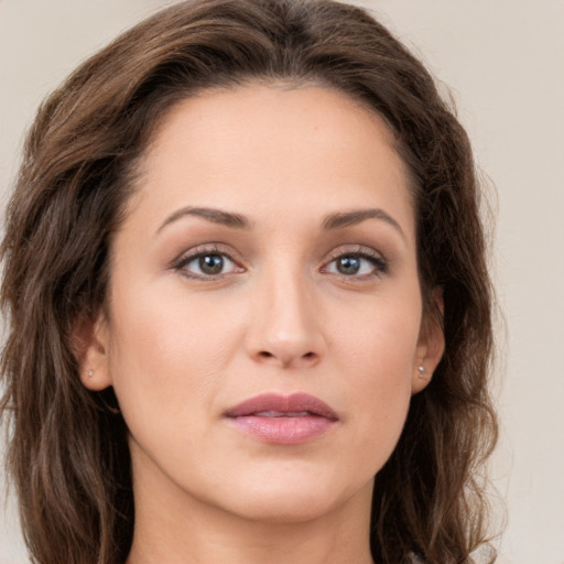 Joyful white young-adult female with long  brown hair and green eyes