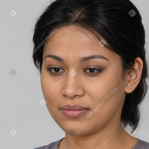 Joyful latino young-adult female with medium  brown hair and brown eyes