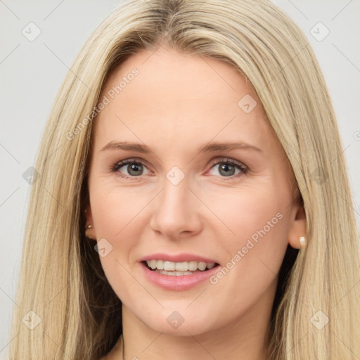 Joyful white adult female with long  brown hair and brown eyes