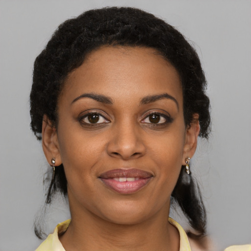 Joyful black young-adult female with medium  brown hair and brown eyes