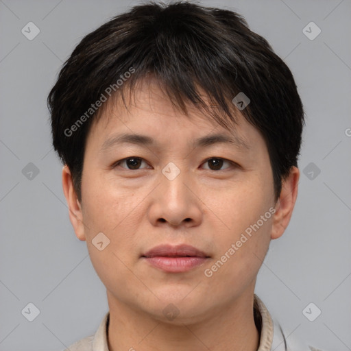 Joyful asian young-adult male with short  brown hair and brown eyes