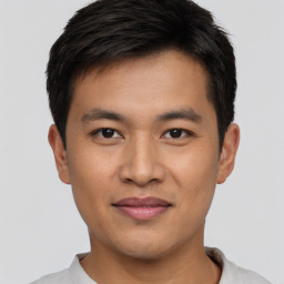 Joyful asian young-adult male with short  black hair and brown eyes