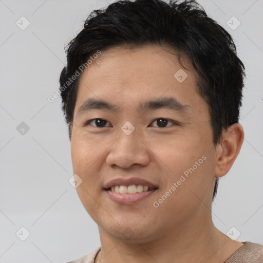 Joyful asian young-adult male with short  brown hair and brown eyes