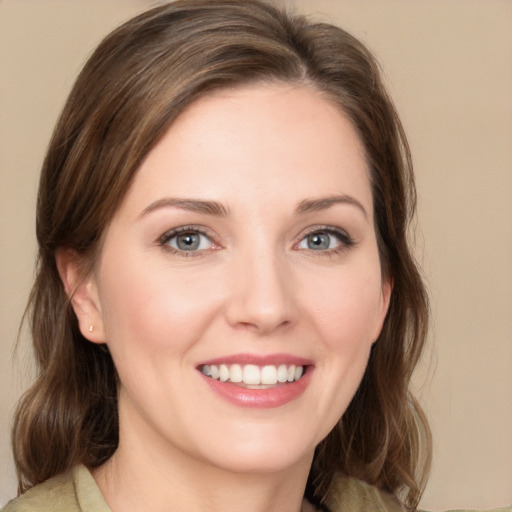 Joyful white young-adult female with medium  brown hair and green eyes