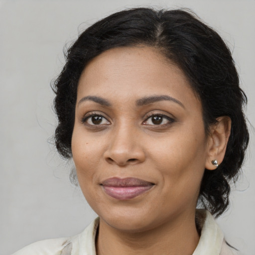 Joyful latino adult female with medium  brown hair and brown eyes