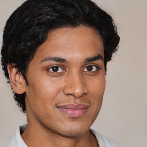 Joyful latino young-adult male with short  brown hair and brown eyes