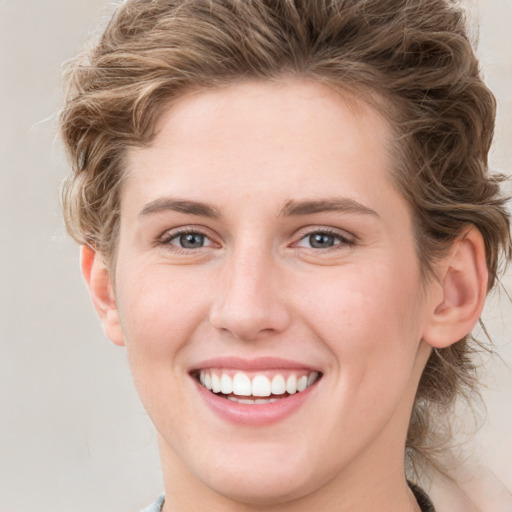 Joyful white young-adult female with medium  brown hair and blue eyes