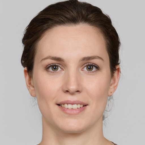 Joyful white young-adult female with medium  brown hair and grey eyes