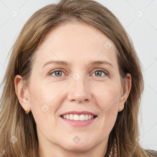 Joyful white young-adult female with long  brown hair and grey eyes