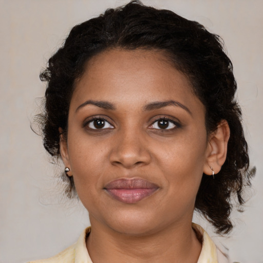 Joyful black young-adult female with medium  brown hair and brown eyes