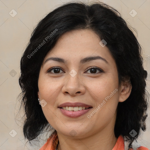 Joyful latino adult female with medium  brown hair and brown eyes