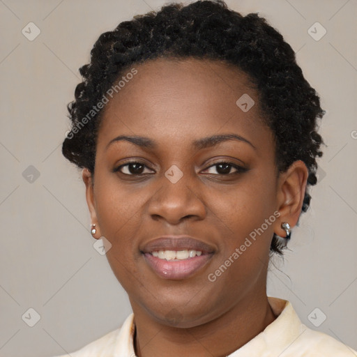 Joyful black young-adult female with short  black hair and brown eyes