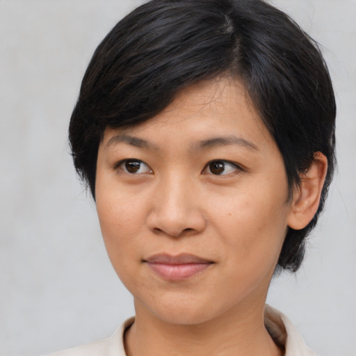 Joyful asian young-adult female with medium  black hair and brown eyes