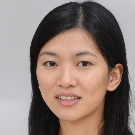 Joyful asian young-adult female with long  black hair and brown eyes