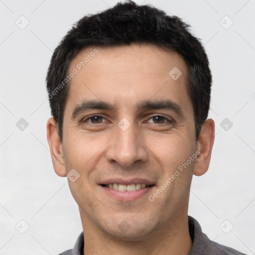 Joyful white young-adult male with short  black hair and brown eyes