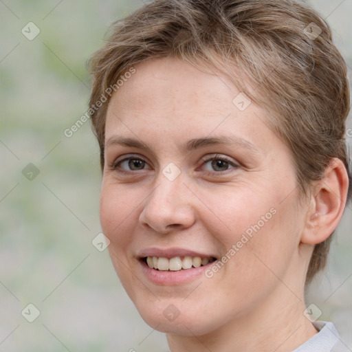 Joyful white young-adult female with medium  brown hair and grey eyes