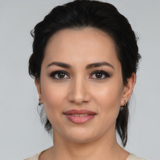 Joyful latino young-adult female with medium  black hair and brown eyes