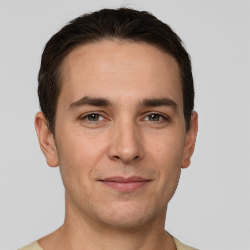 Joyful white young-adult male with short  brown hair and brown eyes