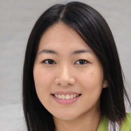 Joyful asian young-adult female with long  brown hair and brown eyes