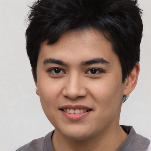 Joyful asian young-adult male with short  black hair and brown eyes