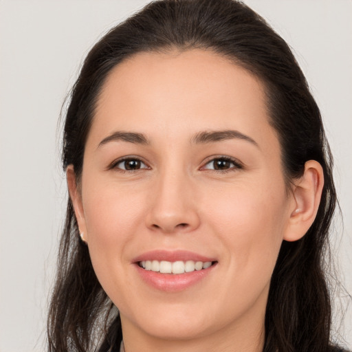 Joyful white young-adult female with long  brown hair and brown eyes