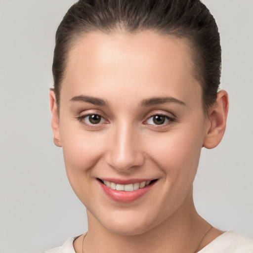 Joyful white young-adult female with short  brown hair and brown eyes