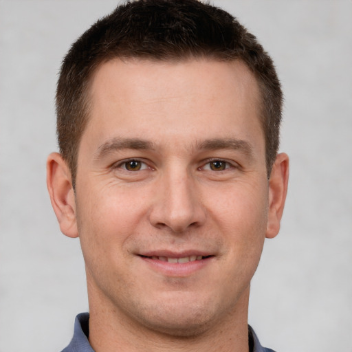 Joyful white young-adult male with short  brown hair and brown eyes