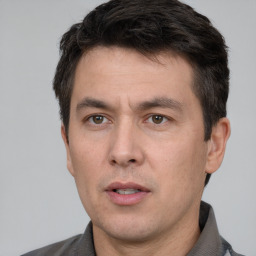 Neutral white adult male with short  black hair and brown eyes