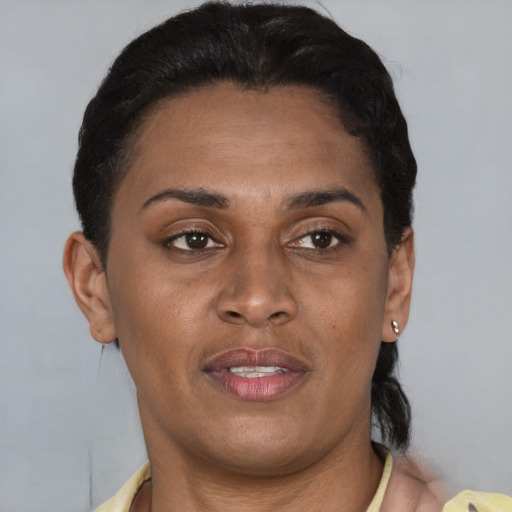 Joyful latino adult female with short  brown hair and brown eyes